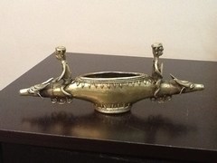 brass men on cows