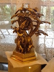 Krishna and cow under tree